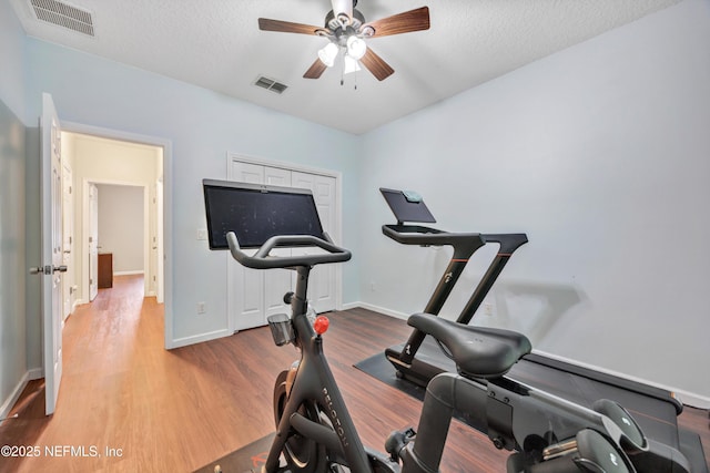 2502 Willow Creek Dr, Fleming Island, FL 32003 - exercise area with a ceiling fan, wood finished floors, and a textured ceiling