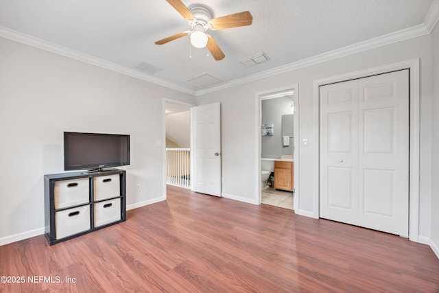 2502 Willow Creek Dr, Fleming Island, FL 32003 - unfurnished bedroom featuring wood finished floors, ornamental molding, a closet, connected bathroom, and a ceiling fan