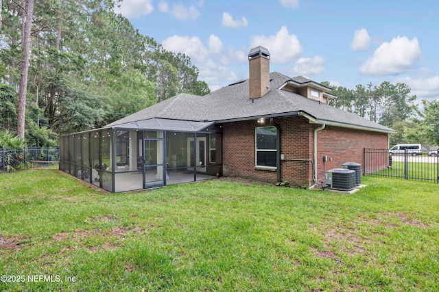 2502 Willow Creek Dr, Fleming Island, FL 32003 - back of house with a fenced backyard, a shingled roof, a chimney, and brick siding