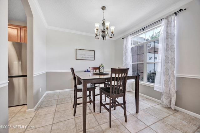 2502 Willow Creek Dr, Fleming Island, FL 32003 - dining area featuring a chandelier, crown molding, light tile patterned floors, arched walkways, and a textured ceiling