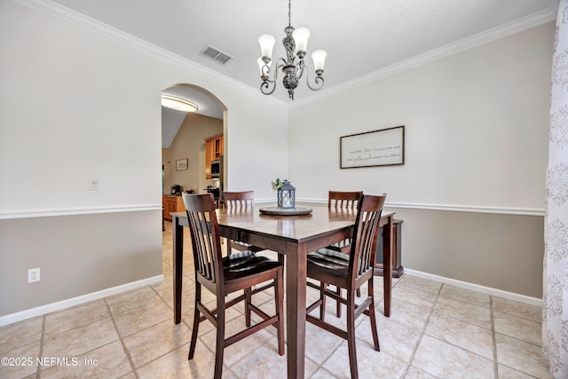 2502 Willow Creek Dr, Fleming Island, FL 32003 - dining room featuring arched walkways, ornamental molding, light tile patterned flooring, a chandelier, and a textured ceiling