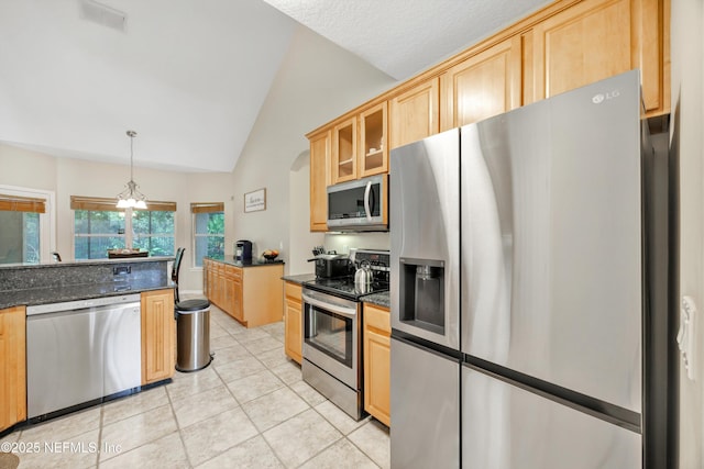 2502 Willow Creek Dr, Fleming Island, FL 32003 - kitchen featuring stainless steel appliances, vaulted ceiling, light tile patterned floors, glass insert cabinets, and light brown cabinetry