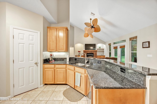 2502 Willow Creek Dr, Fleming Island, FL 32003 - kitchen with ceiling fan, a peninsula, dark stone counters, light tile patterned flooring, and light brown cabinetry