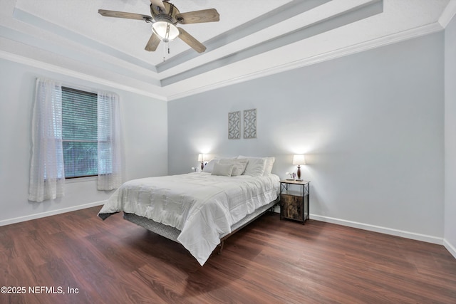 2502 Willow Creek Dr, Fleming Island, FL 32003 - bedroom featuring a tray ceiling, wood finished floors, crown molding, and a ceiling fan