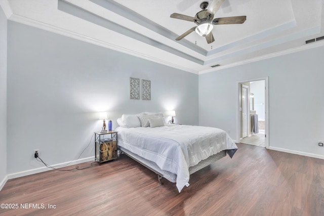 2502 Willow Creek Dr, Fleming Island, FL 32003 - bedroom featuring a tray ceiling, wood finished floors, crown molding, and ceiling fan