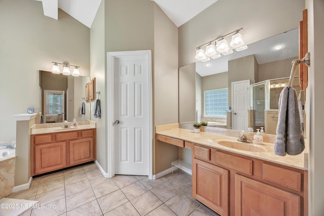 2502 Willow Creek Dr, Fleming Island, FL 32003 - full bath featuring high vaulted ceiling, a stall shower, two vanities, a garden tub, and tile patterned flooring