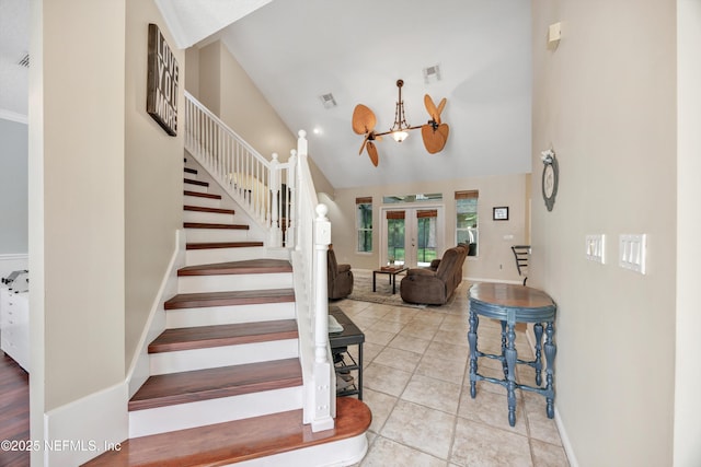 2502 Willow Creek Dr, Fleming Island, FL 32003 - staircase with french doors, tile patterned floors, a chandelier, and high vaulted ceiling