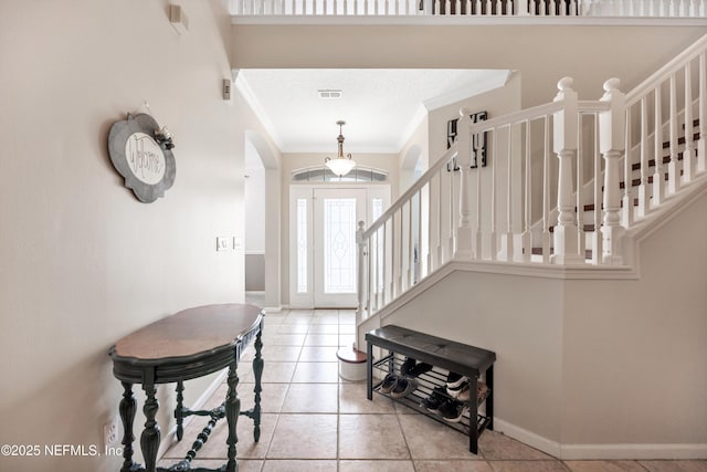 2502 Willow Creek Dr, Fleming Island, FL 32003 - tiled foyer entrance featuring arched walkways, ornamental molding, and stairway
