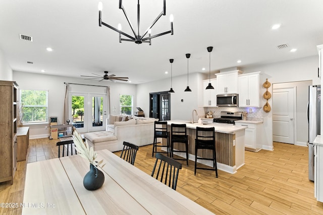 133 Wambaw Dr, Saint Johns, FL 32259 - dining area featuring a chandelier, a ceiling fan, recessed lighting, and light wood-type flooring