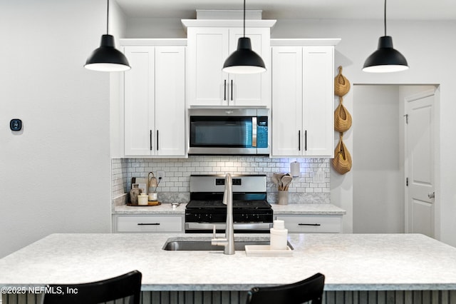 133 Wambaw Dr, Saint Johns, FL 32259 - kitchen featuring appliances with stainless steel finishes, tasteful backsplash, light countertops, and white cabinetry