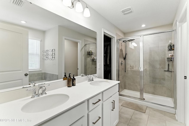 133 Wambaw Dr, Saint Johns, FL 32259 - full bathroom featuring a stall shower, tile patterned floors, double vanity, a walk in closet, and recessed lighting