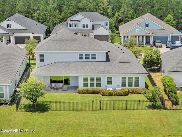 246 Glenneyre Cir, Saint Augustine, FL 32092 - back of house featuring a fenced backyard, a patio, an outdoor living space, a shingled roof, and a view of trees