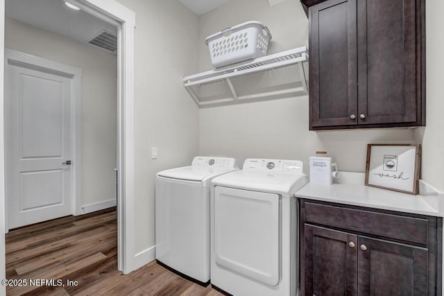 246 Glenneyre Cir, Saint Augustine, FL 32092 - washroom featuring cabinet space, washer and dryer, and wood finished floors