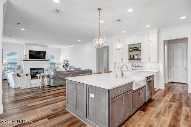 246 Glenneyre Cir, Saint Augustine, FL 32092 - kitchen with dishwasher, white cabinets, a chandelier, ornamental molding, and open shelves