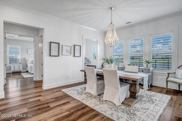 246 Glenneyre Cir, Saint Augustine, FL 32092 - dining space featuring a chandelier, wood finished floors, and ornamental molding