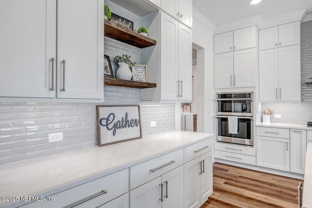 246 Glenneyre Cir, Saint Augustine, FL 32092 - kitchen with open shelves, tasteful backsplash, double oven, white cabinets, and recessed lighting