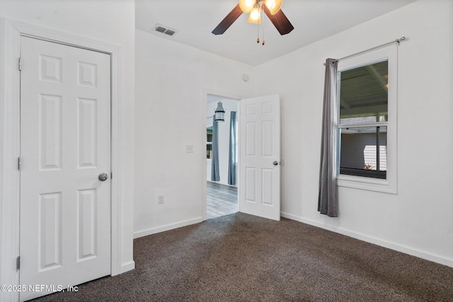 5834 Harris Ave, Jacksonville, FL 32211 - unfurnished bedroom featuring dark carpet and ceiling fan