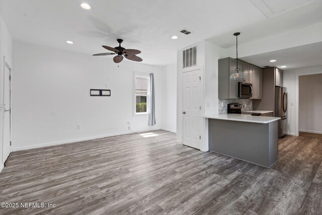 5834 Harris Ave, Jacksonville, FL 32211 - kitchen featuring stainless steel appliances, a ceiling fan, wood finished floors, light countertops, and recessed lighting