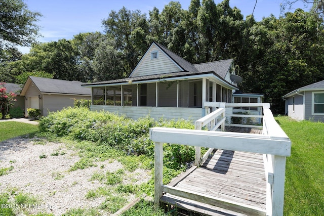 5834 Harris Ave, Jacksonville, FL 32211 - back of property featuring a sunroom and a shingled roof