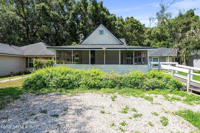 5834 Harris Ave, Jacksonville, FL 32211 - view of front of house with a sunroom and roof with shingles