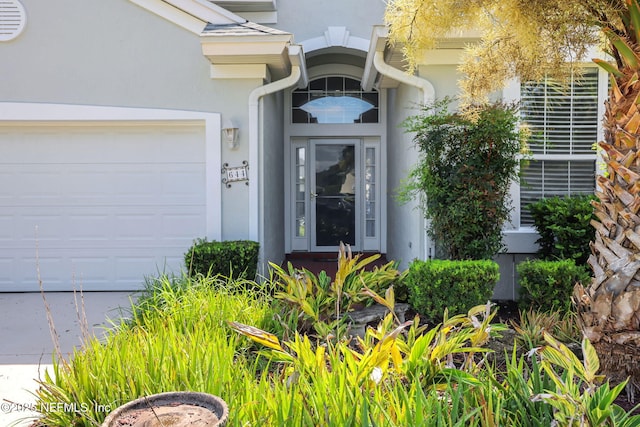 644 Casa Fuerta Ln, Saint Augustine, FL 32080 - view of exterior entry with a garage and stucco siding