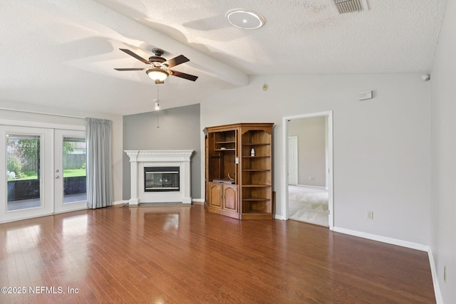 1835 Harbor Island Dr, Fleming Island, FL 32003 - unfurnished living room featuring a textured ceiling, wood finished floors, a glass covered fireplace, and a ceiling fan