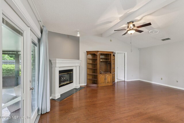 1835 Harbor Island Dr, Fleming Island, FL 32003 - unfurnished living room featuring wood finished floors, ceiling fan, a glass covered fireplace, and a textured ceiling