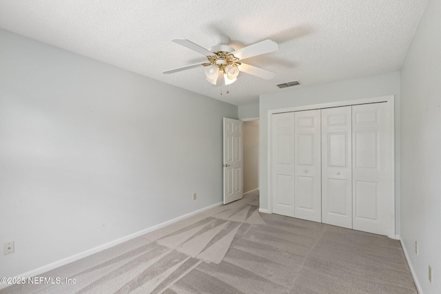 1835 Harbor Island Dr, Fleming Island, FL 32003 - unfurnished bedroom with light carpet, a textured ceiling, a closet, and ceiling fan