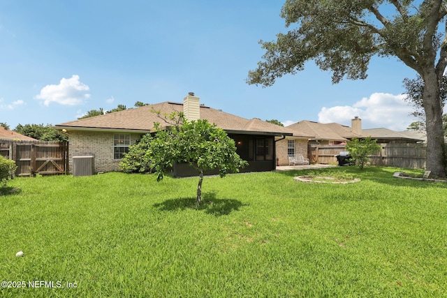 1835 Harbor Island Dr, Fleming Island, FL 32003 - back of house featuring brick siding, a chimney, a sunroom, and a shingled roof