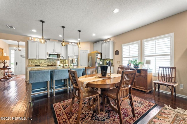 141 Mediterra Ave, Ponte Vedra, FL 32081 - dining area featuring a textured ceiling, dark wood finished floors, and recessed lighting