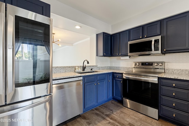 7855 La Sierra Ct Unit 7855, Jacksonville, FL 32256 - kitchen with stainless steel appliances, blue cabinets, dark wood-type flooring, crown molding, and decorative backsplash