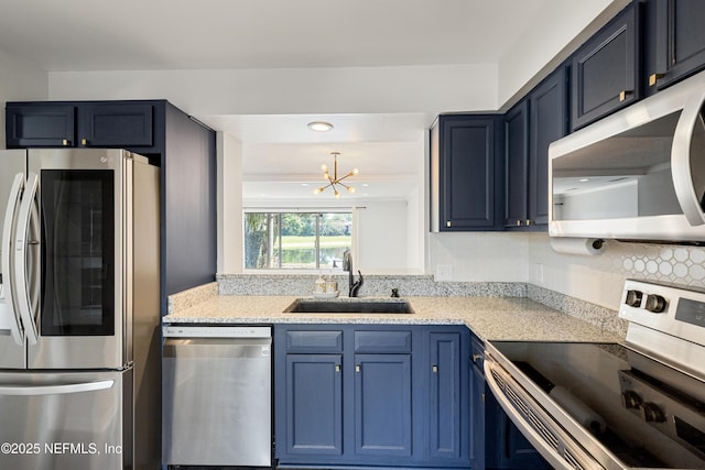 7855 La Sierra Ct Unit 7855, Jacksonville, FL 32256 - kitchen with appliances with stainless steel finishes, a chandelier, blue cabinets, light stone counters, and recessed lighting