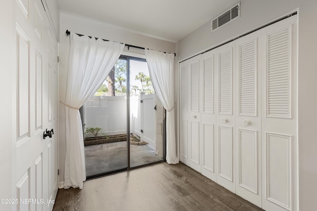 7855 La Sierra Ct Unit 7855, Jacksonville, FL 32256 - unfurnished bedroom featuring access to exterior, wood finished floors, and a closet