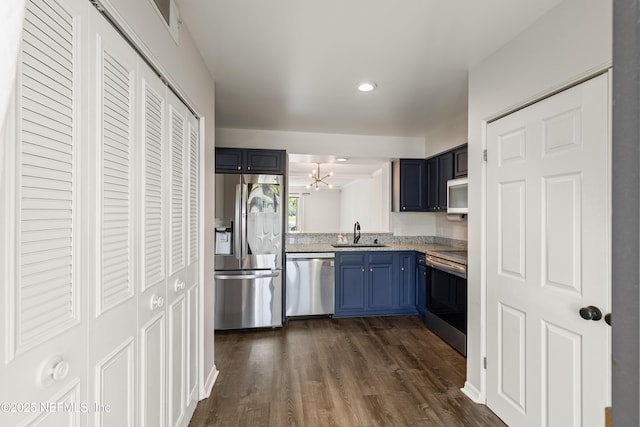 7855 La Sierra Ct Unit 7855, Jacksonville, FL 32256 - kitchen featuring appliances with stainless steel finishes, blue cabinets, light countertops, a chandelier, and dark wood-style floors