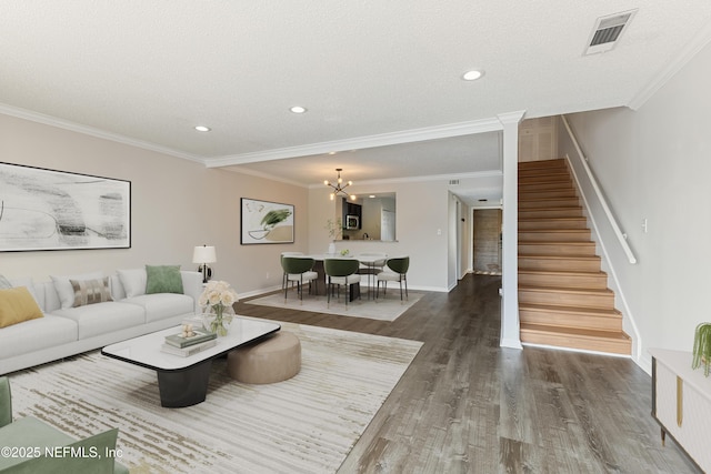 7855 La Sierra Ct Unit 7855, Jacksonville, FL 32256 - living room with stairs, wood finished floors, recessed lighting, ornamental molding, and a chandelier