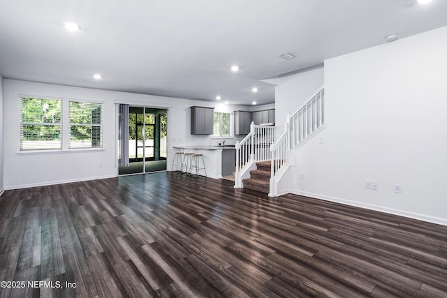 155 Gourd Island Way, Saint Johns, FL 32259 - unfurnished living room with dark wood-style flooring, stairs, and recessed lighting