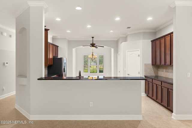 100 Cummer Way, Saint Augustine, FL 32095 - kitchen featuring stainless steel refrigerator with ice dispenser, dark countertops, a peninsula, ceiling fan, and ornamental molding