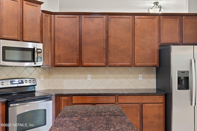 100 Cummer Way, Saint Augustine, FL 32095 - kitchen with stainless steel appliances, dark stone counters, and tasteful backsplash