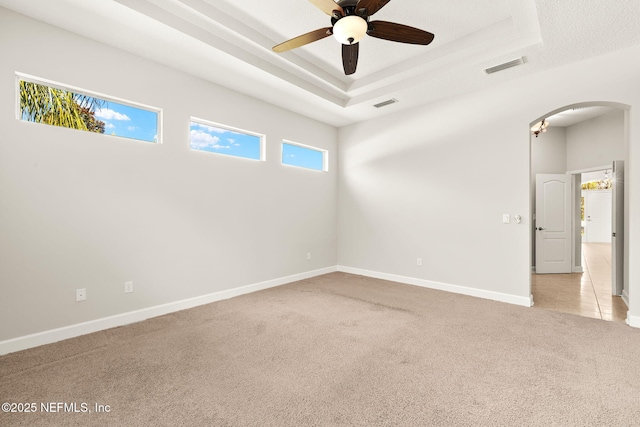 100 Cummer Way, Saint Augustine, FL 32095 - empty room featuring light carpet, arched walkways, a ceiling fan, and a tray ceiling