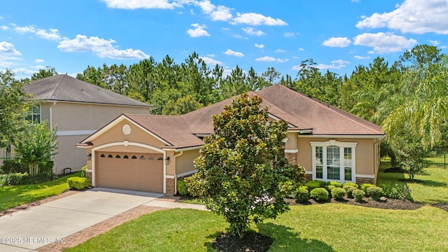 100 Cummer Way, Saint Augustine, FL 32095 - view of front of house with stucco siding, a garage, concrete driveway, and stone siding