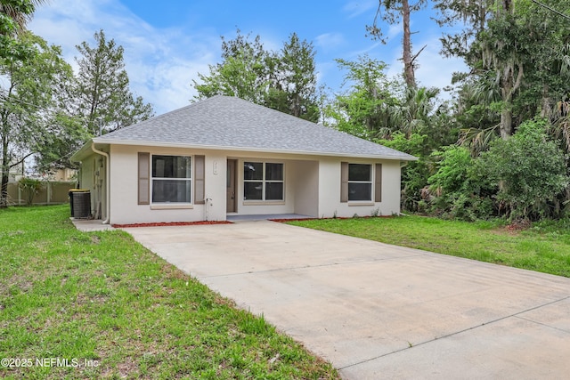 204 S Forsyth Ln, Bunnell, FL 32110 - view of front of home featuring stucco siding, a front lawn, concrete driveway, and a shingled roof