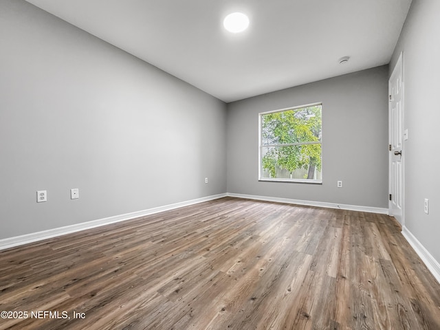 204 S Forsyth Ln, Bunnell, FL 32110 - empty room with wood finished floors