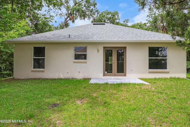 204 S Forsyth Ln, Bunnell, FL 32110 - back of house with a shingled roof, stucco siding, and a yard