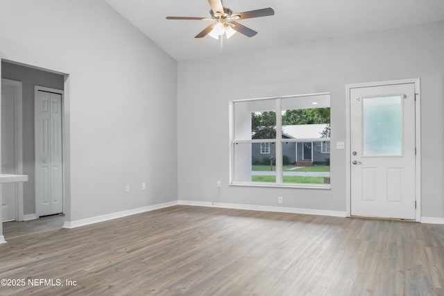 204 S Forsyth Ln, Bunnell, FL 32110 - unfurnished living room with ceiling fan, wood finished floors, and lofted ceiling