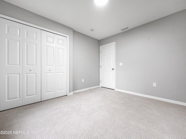 204 S Forsyth Ln, Bunnell, FL 32110 - unfurnished bedroom featuring light carpet and a closet