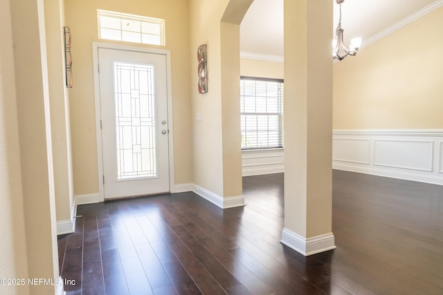 11115 Parkside Preserve Way, Jacksonville, FL 32257 - foyer entrance featuring arched walkways, ornamental molding, and dark wood finished floors