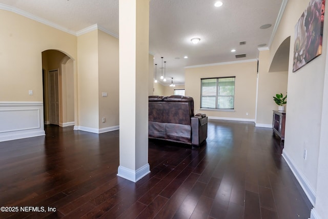 11115 Parkside Preserve Way, Jacksonville, FL 32257 - living area featuring dark wood-type flooring, arched walkways, crown molding, a textured ceiling, and recessed lighting