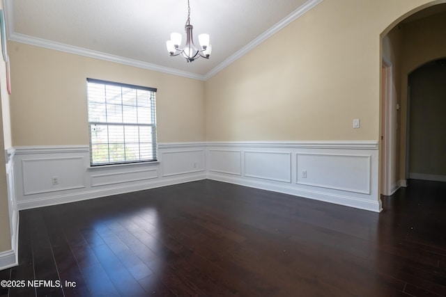 11115 Parkside Preserve Way, Jacksonville, FL 32257 - unfurnished room with arched walkways, a chandelier, dark wood-type flooring, crown molding, and wainscoting