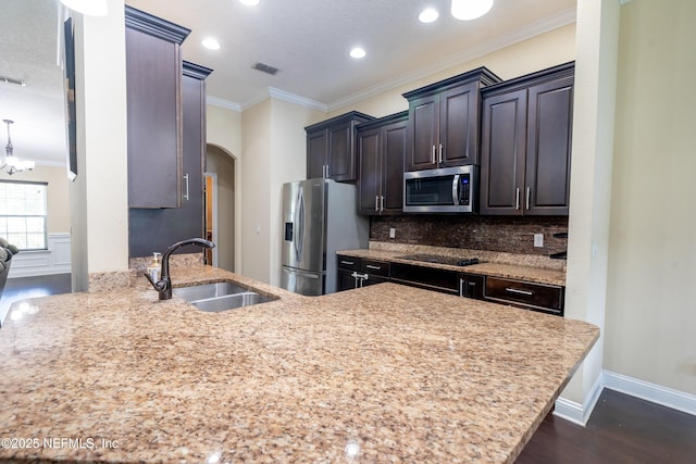 11115 Parkside Preserve Way, Jacksonville, FL 32257 - kitchen featuring appliances with stainless steel finishes, dark wood-style floors, arched walkways, ornamental molding, and decorative backsplash