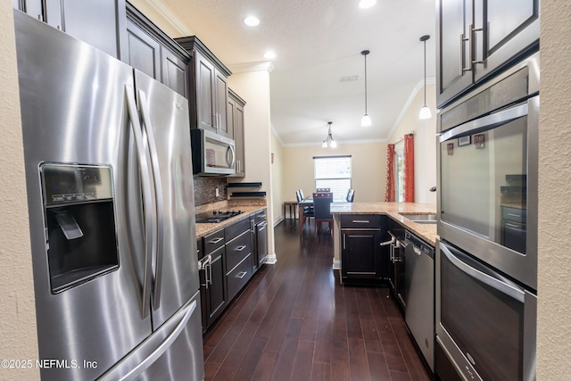 11115 Parkside Preserve Way, Jacksonville, FL 32257 - kitchen featuring stainless steel appliances, crown molding, light stone counters, dark wood-style floors, and a peninsula